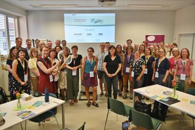 Eine Gruppe Menschen mit einer Präsentation der Klimaplattform www.klima-engagiert-in-halle.de im Hindergrund